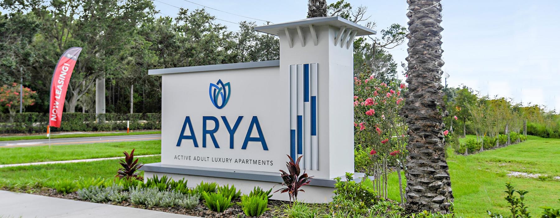 Settle into comfort at Arya at Windermere 55+ Active Adult Living a white sign with blue lettering