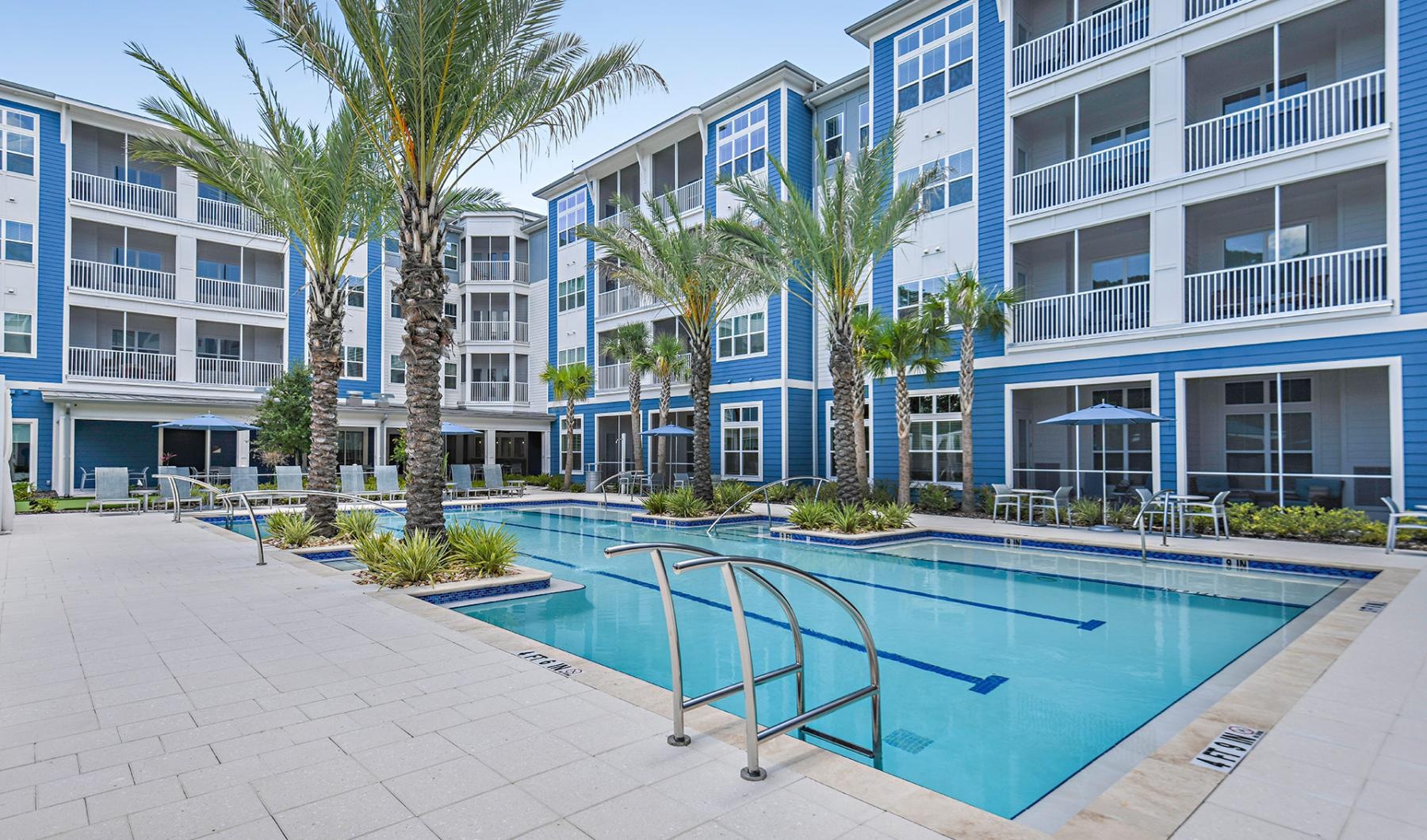 Find your perfect fit at Arya at Windermere 55+ Active Adult Living a pool in front of a building