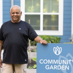 a man standing next to a sign