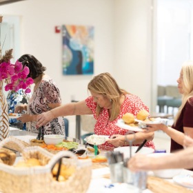 a line of people getting food together