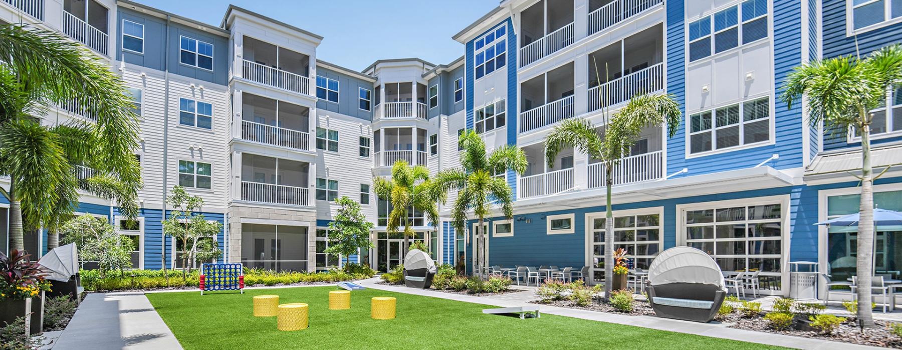 a building with a lawn and trees
