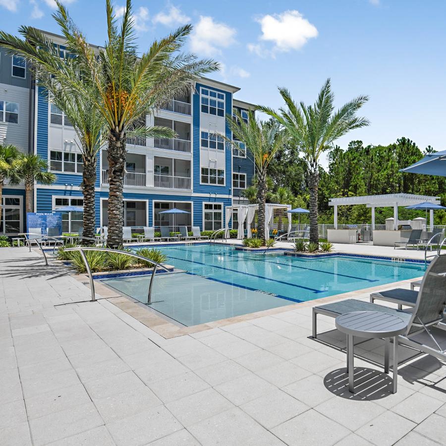 Find your perfect fit at Arya at Windermere 55+ Active Adult Living a pool with chairs around it