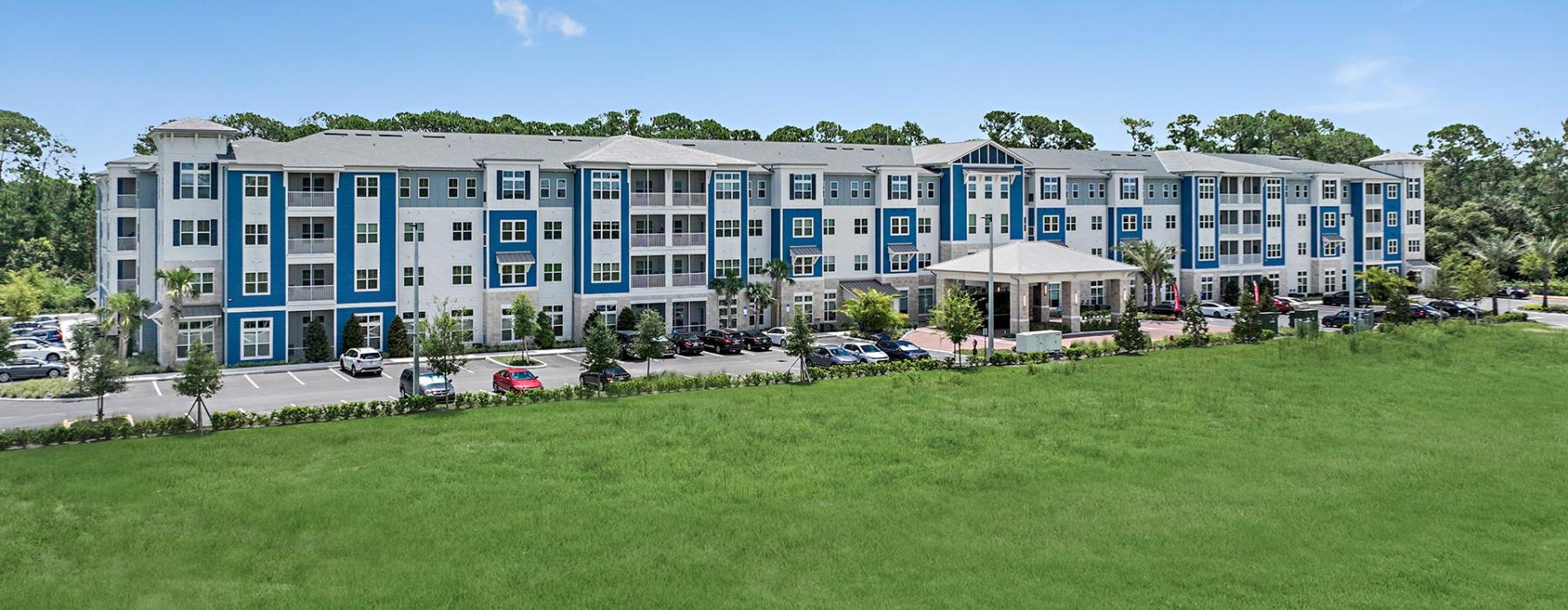 a large building with a lawn in front of it
